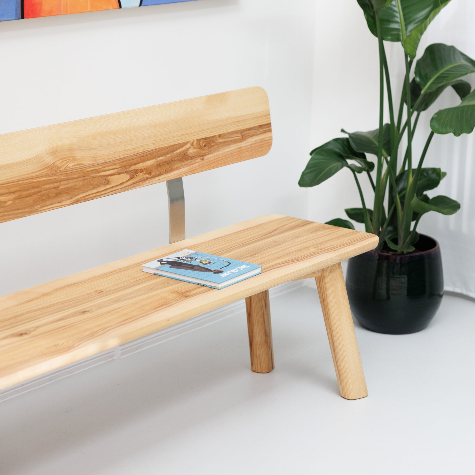 Nachhaltige Esszimmerbank mit Lehne aus robustem Naturholz und minimalistischen Metall-Elementen