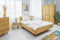 Nachhaltiges Schlafzimmer mit Bett und Nachttisch aus Massivholz Wildeiche